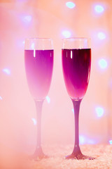 toast of champagne glasses background blurred lights red pink new year