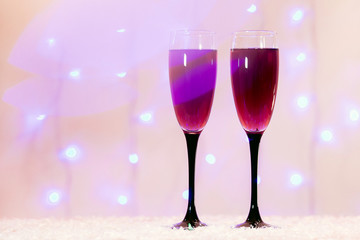 toast of champagne glasses background blurred lights red pink new year