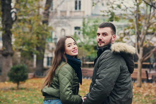 Young loving couple on a city street . Romantic couple in autumn city walk