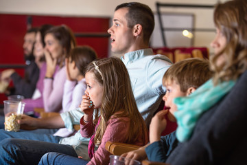 Fototapeta premium Number of people enjoying film screening and popcorn