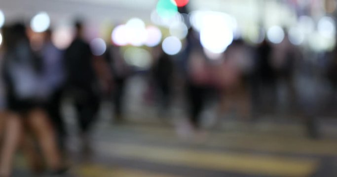 Blur of people walking in street at night