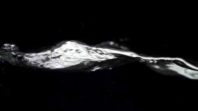 Slo-motion water against black drop