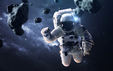 Fototapeta na wymiar Science fiction space wallpaper with astronaut at the spacewalk. Elements of this image furnished by NASA