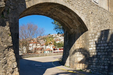 View of Herceg Novi city through the arch of the ancient fortress Forte Mare (Sea Fortress). Montenegro