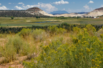 Fototapeta na wymiar Sugarloaf dome rising above green valley near Boulder, Utah scenic view from Scenic Byway 12 in Grand Staircase - Escalante National Monument