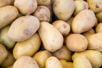 fresh organic potatoes on stand in supermarket