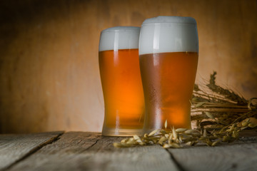 Beer in frosty mugs on rustic background