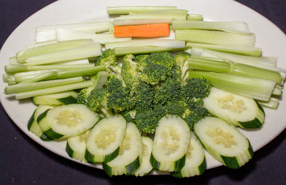 One Carrot, Broccoli Heads, Cucumber Slices and Celery Sticks