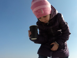 girl beggar with a cup of coffee