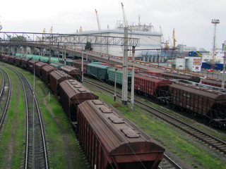 Railways in train parking at the orange sunset panoramic view background. Freight train arrived at the station.