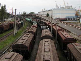 Railways in train parking at the orange sunset panoramic view background. Freight train arrived at the station.