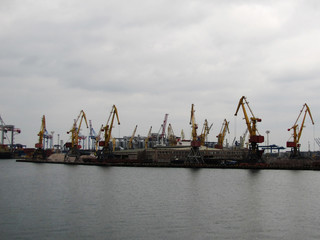 Fototapeta na wymiar View on trading seaport with cranes, cargoes and the ship