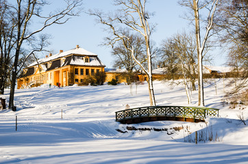 Wooded arch footbridge on a snow covered landscape. Bogstadvannet area in Oslo Norway