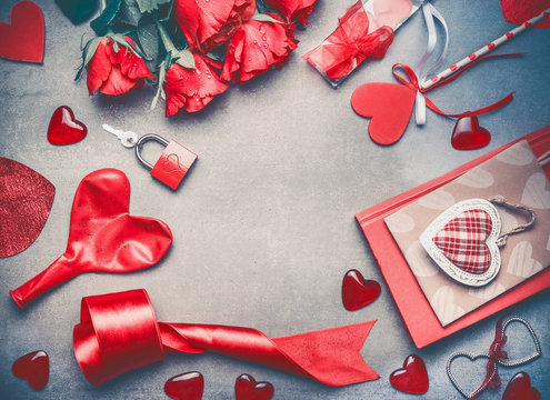 Love and Valentines day concept. Lovely red roses , dating accessories,  hearts, book ,lock and keys on gray background, frame, top view. Layout for greeting card, anniversary and invitations.
