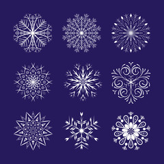 Snowflakes set on dark blue background. Winter Holidays Decorative design elements.