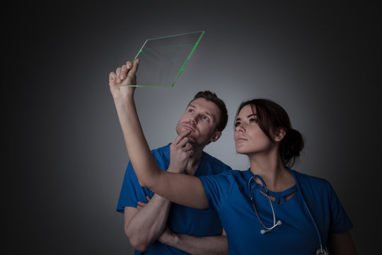 Doctors holding futuristic transparent tablet pc