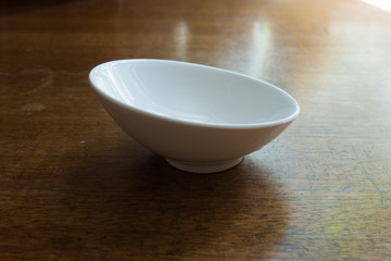 Slighly skew empty white ceramic sauce boat