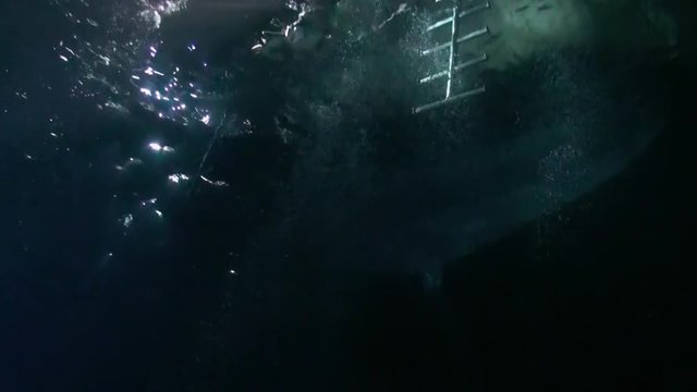 Scuba diver with flashlight on background of bottom at night underwater. Amazing unique beautiful video. Relax.