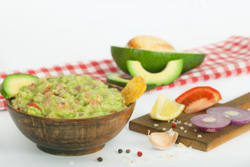 Guacamole with vegetables and snacks in a wooden bowl, vegan snack, vegetarian concept dinner.