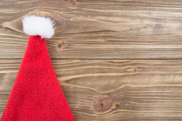 Obraz na płótnie Canvas Santa Claus hat on a wooden background