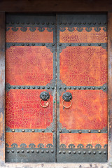 Red cracked paint chinese traditional door with door knockers, China