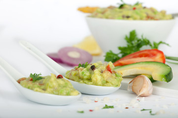 Tortilla guacamole dip in white bowl and spoons. Fresh Vegetable dip.