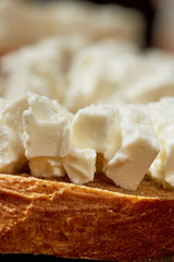 Cheese, vegetables, fruits and spices. Bread, olives and crackers. Mediterranean diet and cuisine. Dark background.