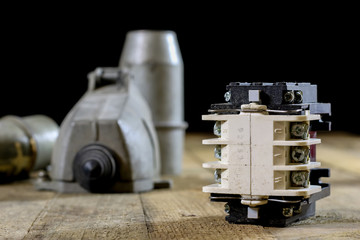Old plug and socket high voltage. Old electrical accessories. Wooden table.