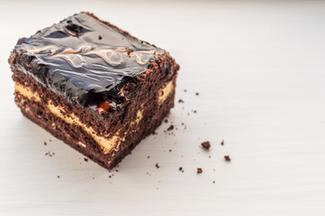 close up of a chocolate syrup on a cake on white background