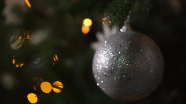 Close up shot of christmas toy spinning on the tree. It is beautiful traditional decoration.