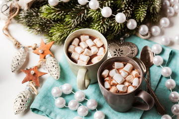 Fototapeta na wymiar Hot chocolates with marshmallows in Christmas setup