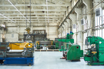 Nobody at industrial workshop with construction crane, drilling and welding machines