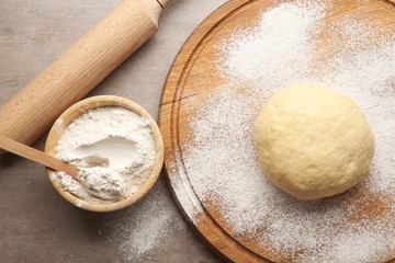 Fototapeta na wymiar Raw dough on wooden board