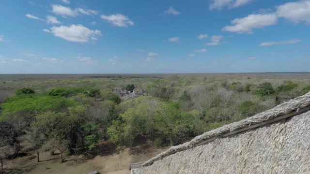 A gimbal shot of woman on top of mayan ruins at ek balam
