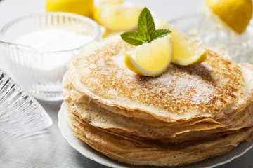 Fotobehang English-style pancakes with lemon and sugar, traditional for Shrove Tuesday. © N.Van Doninck