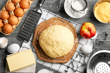 Raw dough and ingredients on kitchen table