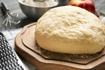 Raw dough on wooden board