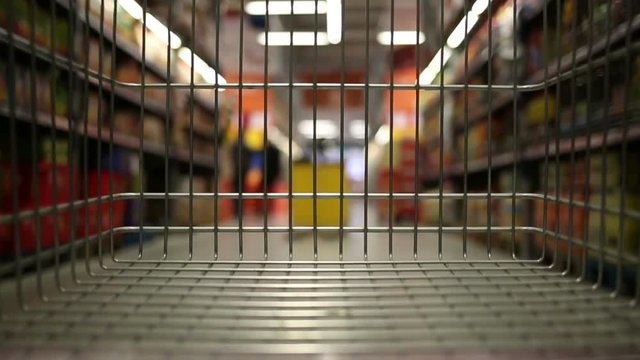 Empty shopping cart moving through supermarket