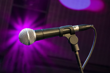 microphone on stage with magenta light background