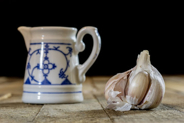 Tasty garlic on a wooden kitchen table. Vegetables in the kitchen atmosphere. Wooden table.