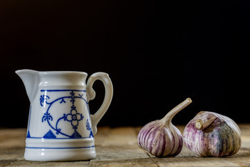 Tasty garlic on a wooden kitchen table. Vegetables in the kitchen atmosphere. Wooden table.