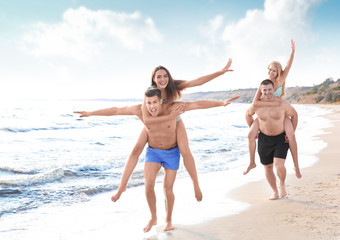 Group of young people playing on beach