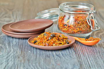 Spices for pilaf on a ceramic saucer.