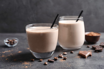 Glasses with milkshakes on table