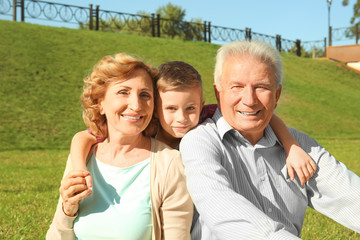 Elderly couple with grandson in park