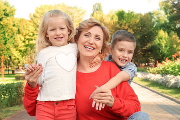 Mature woman with grandchildren in park