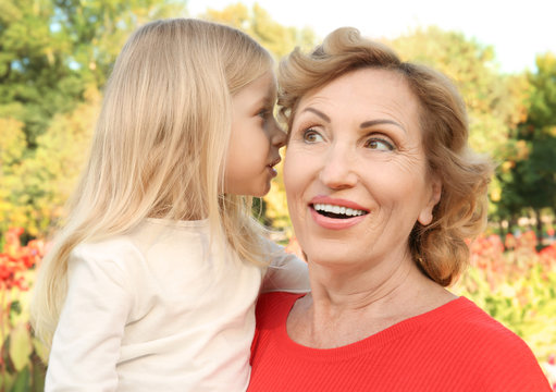 Mature woman with granddaughter in park