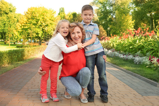 Mature woman with grandchildren in park