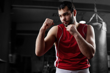 Fototapeta na wymiar Boxing. Portrait of a boxer on the background of the gym