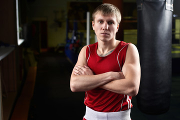 Fototapeta na wymiar Boxing. Portrait of a boxer on the background of the gym